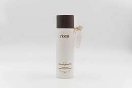 Volume shampoo with white bottle and brown cap. Designed for adding volume to hair.