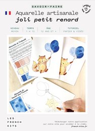 Artisanal watercolor kit featuring a cute fox design, includes paints, brushes, and instructions for creating watercolor paintings.