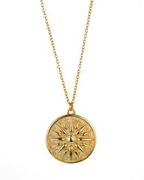Gold and silver sun medallion necklace, featuring a round pendant with a sun design. Available in two color variants.