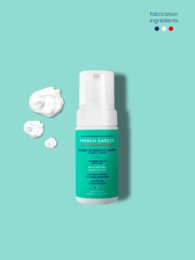 Organic face and body cleanser in a white bottle with a green label. The cleanser is designed to gently cleanse and nourish the skin with natural ingredients.