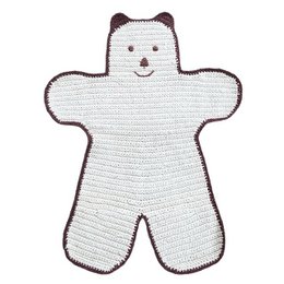 "A hand-crocheted, off-white and brown rug in the shape of a bear, designed for children's rooms. The rug is made of flat cotton and was crafted in Nepal."