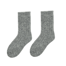 Soft, cozy wool socks for kids in a variety of neutral colors including off-white, grey, and natural brown. The socks feature a ribbed texture and come in sizes ranging from 0-1 year to 3-4 years.