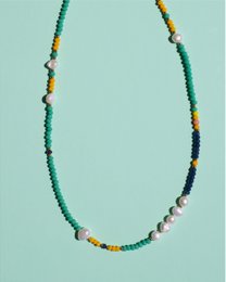 Turquoise beaded necklace with colorful accents, featuring a mix of round and irregular shaped beads in shades of turquoise, yellow, and black.