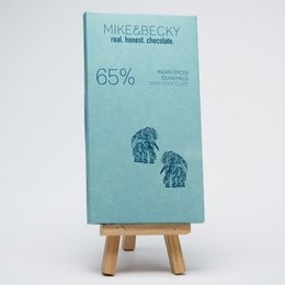 Dark chocolate bar with 65% cocoa content, featuring an intricate elephant design on the packaging. Made with organic ingredients from India.