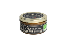 Organic black garlic mustard tapenade in a glass jar. Dark green and gold label. Savory and flavorful condiment made with black garlic, mustard, and other natural ingredients.