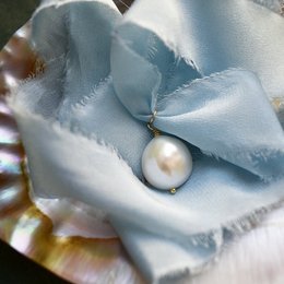 Elegant silk choker with a single pearl accent, perfect for adding a touch of sophistication to any outfit.