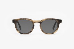 Grey tortoiseshell sunglasses with a classic round frame and metal accents.