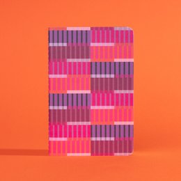 A small notebook with a cover featuring a geometric pattern in shades of purple, orange, and gray.