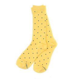 Pale yellow socks with small navy blue polka dots. The socks have a ribbed texture and the text "Three Bees" is visible on the sock.