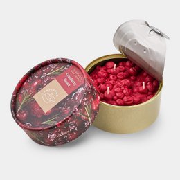 Red tomato-shaped wax candle in round tin container with tomato print lid, handmade scented candle.