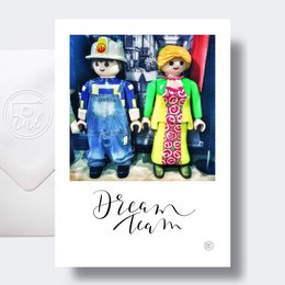 "Wedding cards featuring two construction worker figurines in bright, colorful outfits."