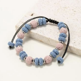  Bracelets made of round and flat beads in natural lava stone tinted pink and blue. Adjustable cord bracelet with a mix of pink and blue beads.