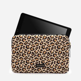 Leopard print iPad sleeve with a zipper closure and a brand logo. The sleeve is made of a durable material and is designed to protect your iPad from scratches and damage.