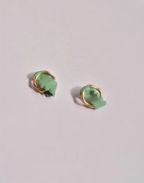 Twisted stud earrings with mint green and gold accents.