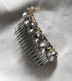 Decorative hair comb with rhinestones in gold and silver colors.