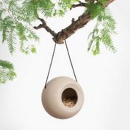 Ceramic bird feeder in beige and grey colors, with a round shape and hanging design, suitable for outdoor use.