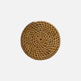Round woven rattan coaster, natural brown color, intricate spiral pattern.
