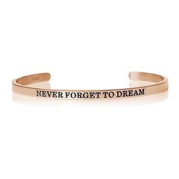 "Elegant 18k rose gold, gold, or white gold cuff bracelet with the inspirational text 'Never Forget To Dream' engraved on the surface. Suitable for everyday wear and as a thoughtful gift."