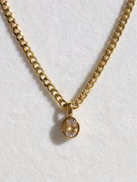 Oval crystal pendant necklace with gold chain.