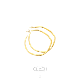 Large organic hoop earrings made of gold-toned metal with a smooth, rounded shape.