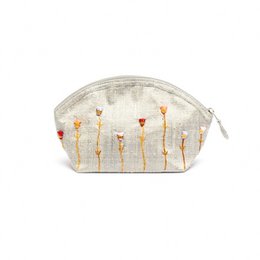Cosmetic bag made of embroidered raw silk in a silver color, suitable for weekend use.