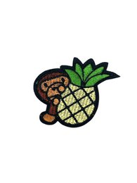  White sneakers with pineapple and monkey embroidered design.