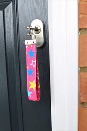 Colorful fabric key fobs with various designs including butterflies, dinosaurs, stars, and bees. Suitable as gifts for women and men.