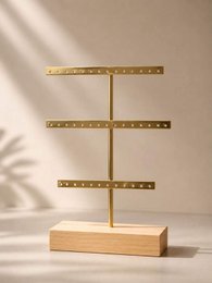 Wooden earring display stand with three horizontal brass bars, minimalist jewelry organizer.