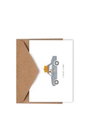 A birthday card featuring a cute cartoon car with a present on its roof, conveying the message "A PRESENT IS COMING" from Studio KATHAN.