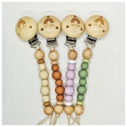 Pacifier cord with colorful wooden beads in various pastel shades including beige, caramel, lilac, and green. The pacifier clips are made of gold-colored metal.