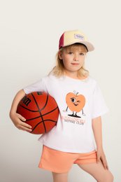  "A white t-shirt with a graphic of a heart-shaped character and the text 'Tasting Club' for a kids jumpsuits product. The t-shirt is paired with orange shorts and the model is wearing a baseball cap."

The product is a kids jumpsuit that includes a white t-shirt with a graphic of a heart-shaped character and the text "Tasting Club". The t-shirt is paired with orange shorts, and the model is wearing a baseball cap. The product is available in various sizes from 18-24 months to 10-11 years, and in the color peach.