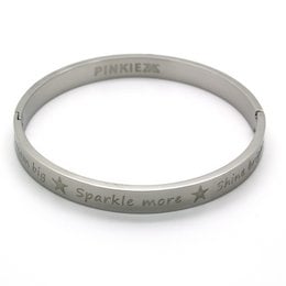 A silver-colored cuff bracelet with the text "Pinkiez" and "Sparkle more" engraved on it.
The product is a silver-colored cuff bracelet from the Pinkiez jewelry brand. The bracelet features the text "Pinkiez" and "Sparkle more" engraved on the surface. The bracelet has a simple, minimalist design that would complement a variety of casual or dressy outfits.