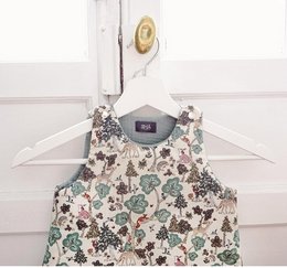 Floral print sleeping bag with green trim, suitable for a baby or toddler.