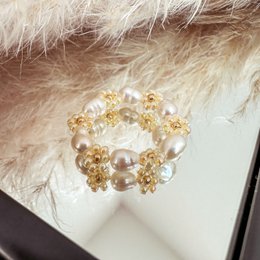  Flower ring made of glass beads in yellow and pearl colors. Stackable ring design with a cluster of glass beads and pearls.