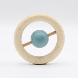 A wooden rattle with a round, colorful bead in the center. Available in pink, ocean, curry, and natural color variants. Suitable for babies.