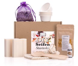 This DIY soap making set includes vegan curd soap, soap bags, and other materials to create your own natural soap. The set contains items in various colors, shapes, and textures, including a purple organza bag.