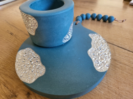 Set of blue and silver tea light holders with textured patterns.