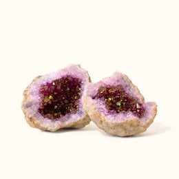 Vibrant pink quartz crystal geode with natural druzy formations, a unique natural gemstone specimen.