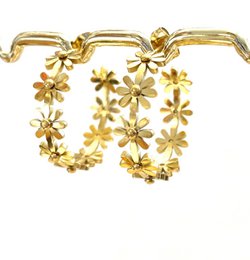 Gold floral hoop earrings with delicate flower details.