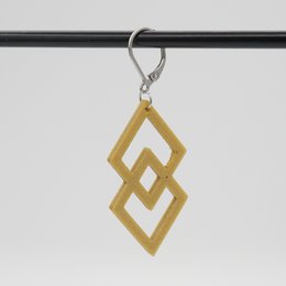 Fussi drop earrings in a variety of colors including galaxy purple, gold, dark red, jade green, turquoise, red, orange, magenta, melon yellow, galaxy blue, black, and white. The earrings feature a diamond-shaped geometric design.