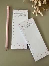 A white planner with a pink pencil, featuring the text "Today will be a good day" and a dotted pattern.