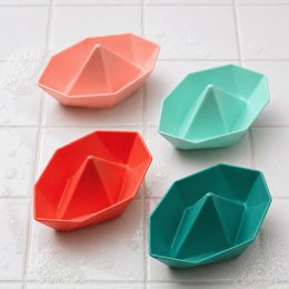Colorful stackable origami boats in coral, red, mint green, and teal. Geometric folded design bath toys for babies.