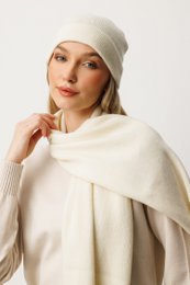 Warm, cozy ecru-colored wool beanie and scarf set. Soft, textured knit material. Versatile accessory for cold weather.