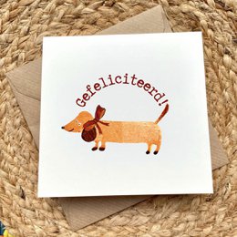 Congratulations card with a dachshund dog illustration and the text "Gefeliciteerd" which means "Congratulations" in Dutch.
