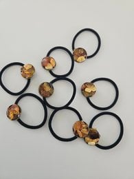 Hairband with amber-colored gemstones, featuring a unique and stylish design for hair accessories.