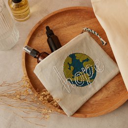  Beige clutch with embroidered globe design, suitable for everyday use or as a stylish accessory.