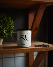 White enamel mug with minimalist black line art design, camping style, durable metal handle.