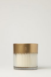  Tall, round amber-colored candle with a gold-toned metal lid and ribbed glass container.