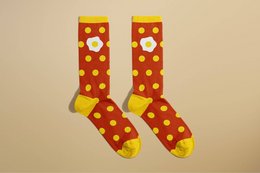 Red and yellow polka dot socks with a fried egg design.