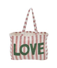 A large, striped beach bag with the word "LOVE" prominently displayed in green letters.